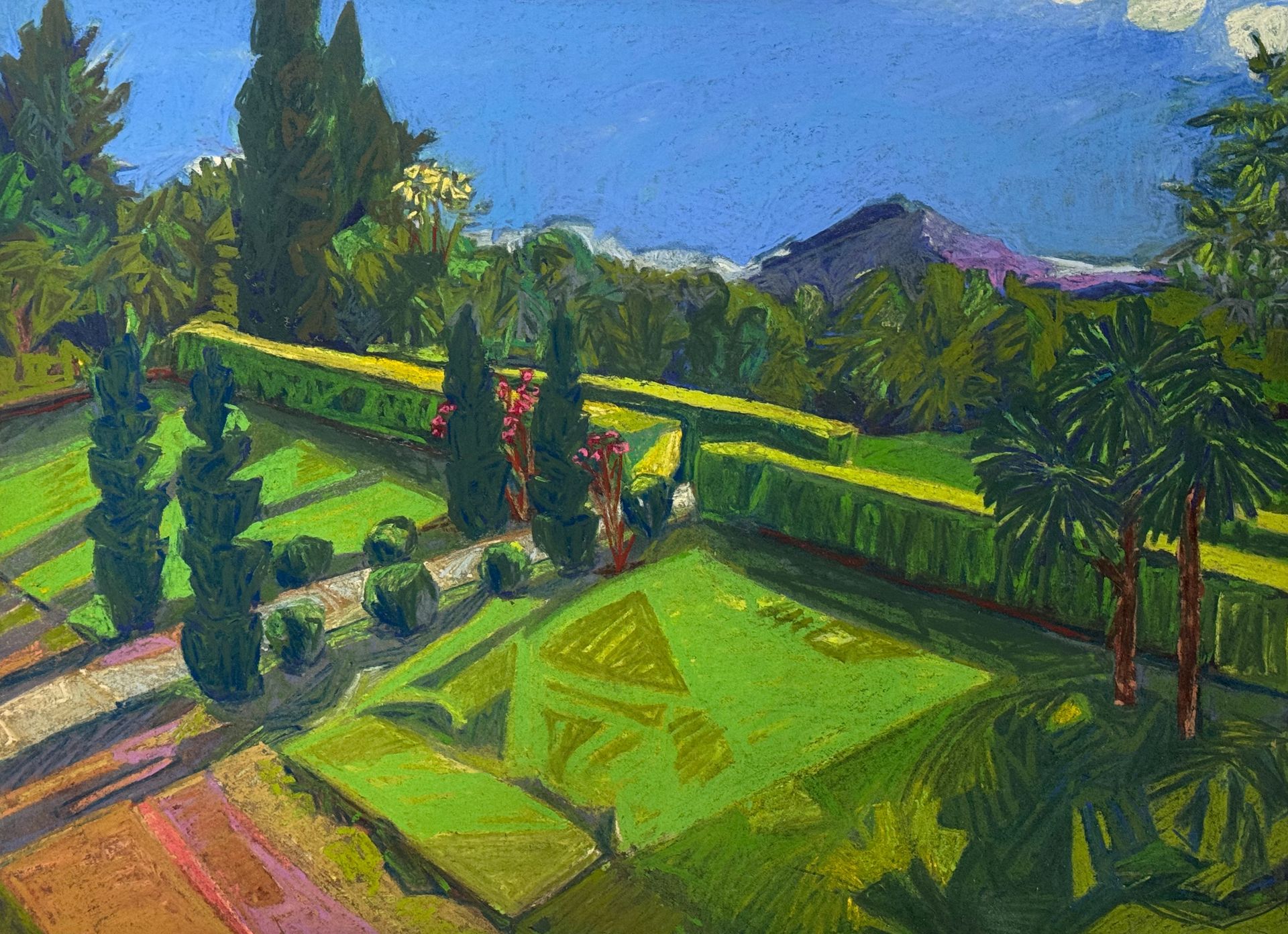 ©Karen Kulyk - Green garden with cypress trees, hedges, and mountain under a blue sky.