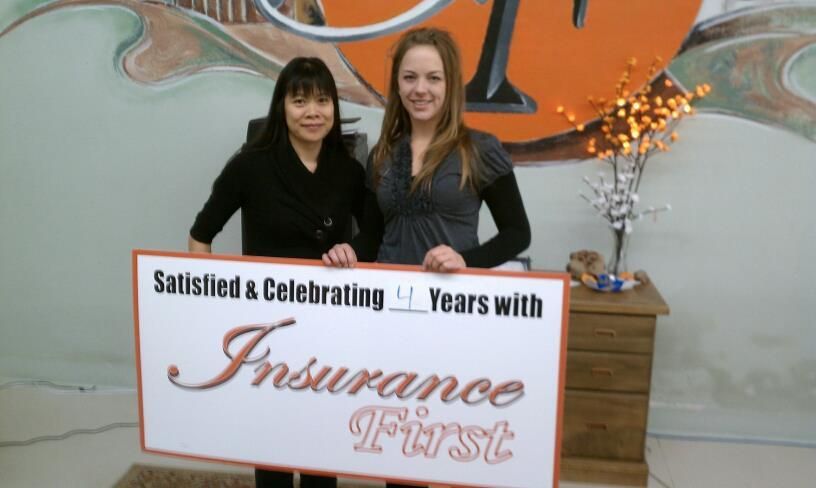 Two women holding a sign that says Insurance First