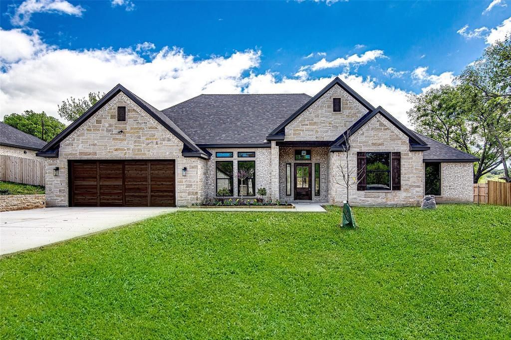 Wooden front door with sidelights, porch, and white pillars.