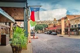 Fort Worth Stockyards street scene with a Texas flag.
