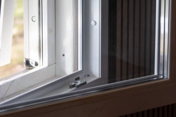 A close-up of a window with a screen on it.