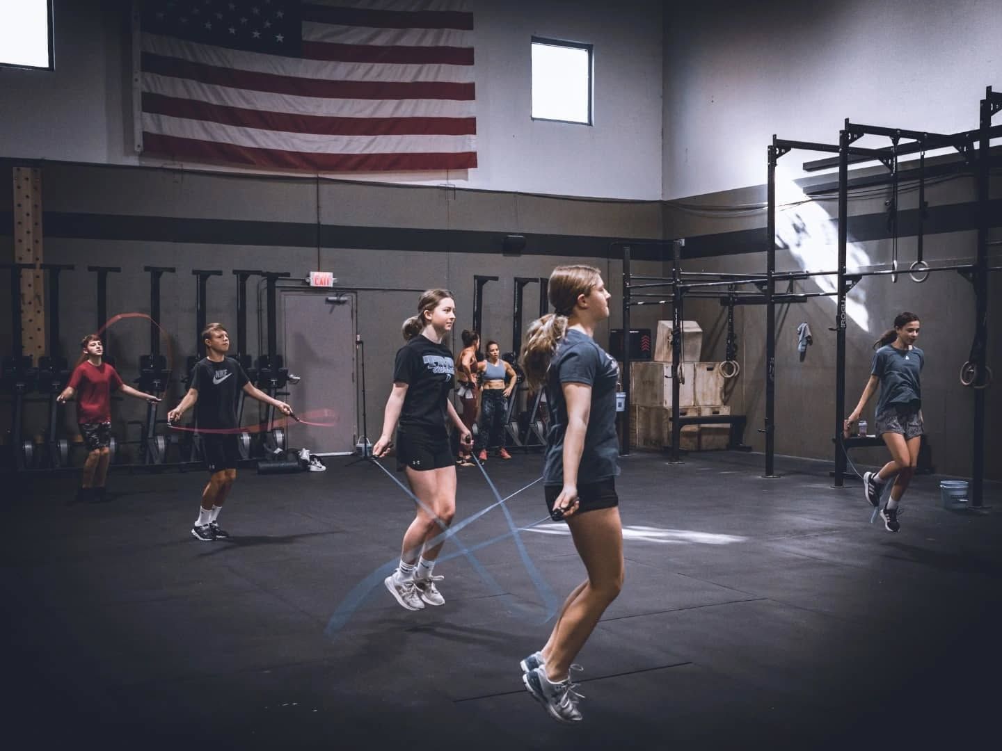 A group of women are jumping rope in a gym.