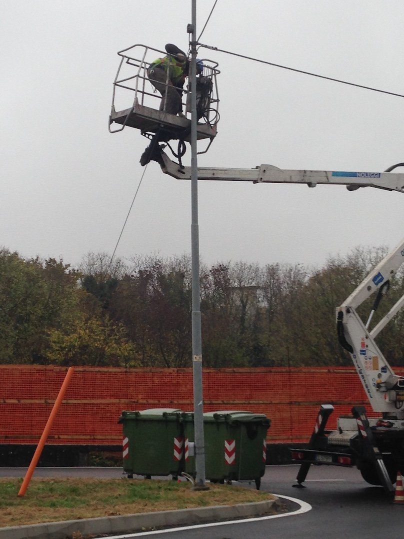 Operaio al lavoro su un palo con antenna