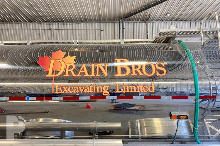 Drain bros excavating limited is written on the side of a truck