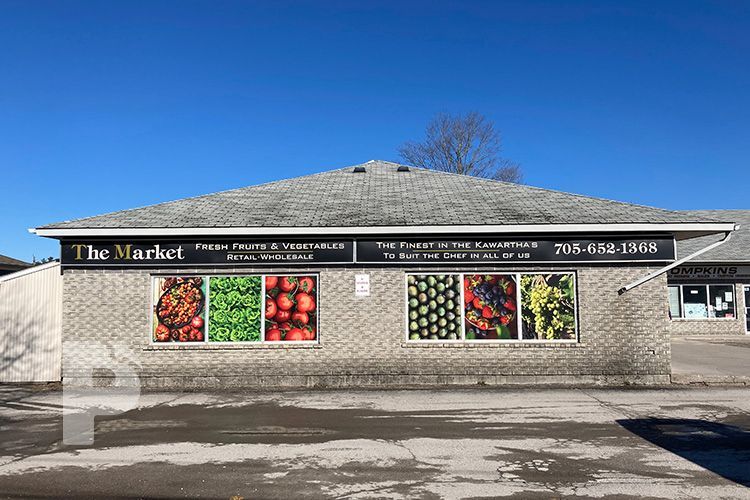 A brick building with a sign that says `` the market '' on it.
