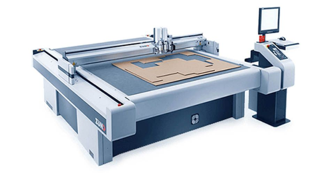 A large machine is sitting on top of a blue surface.