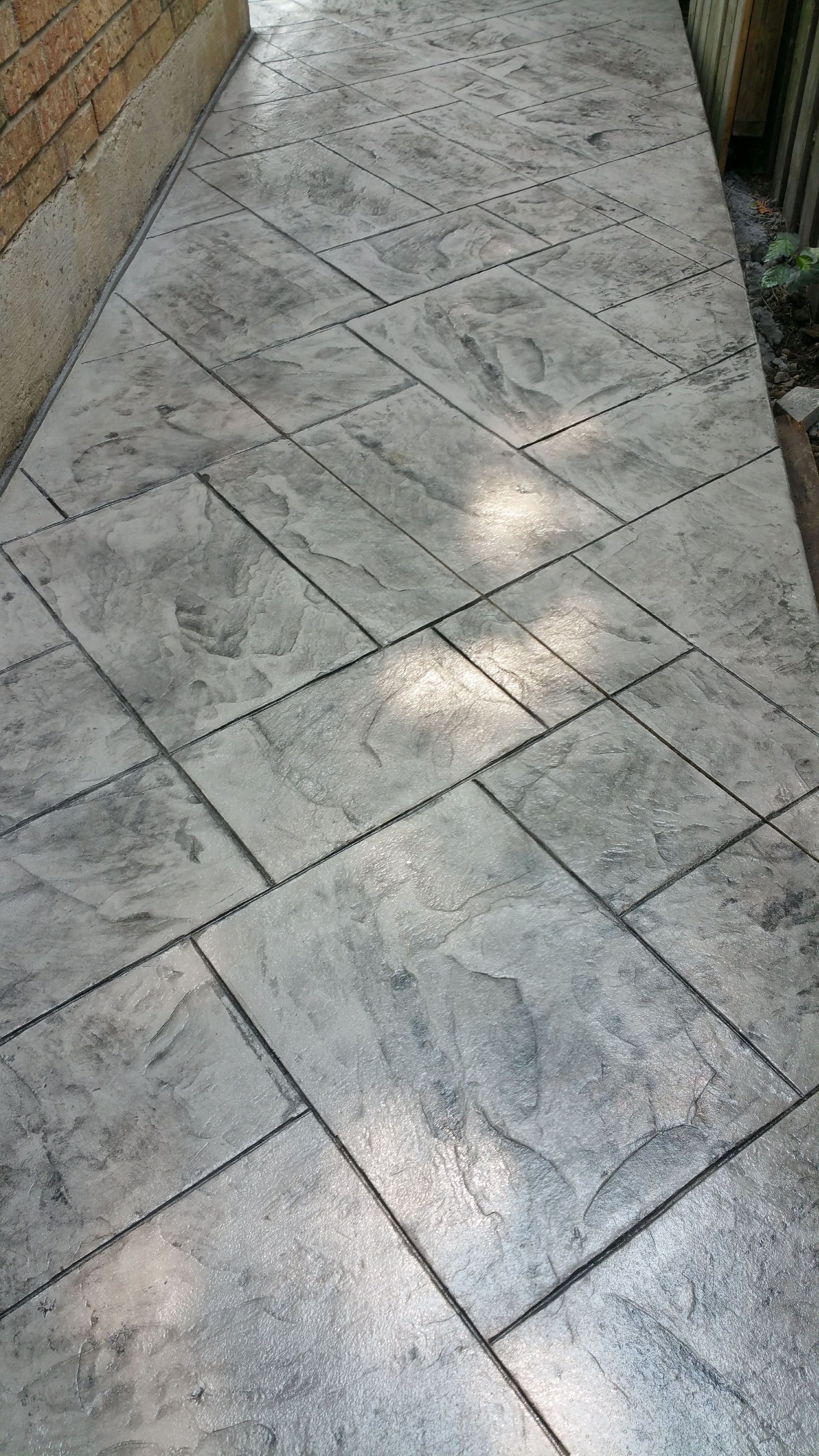 A close up of a concrete walkway with a pattern on it.