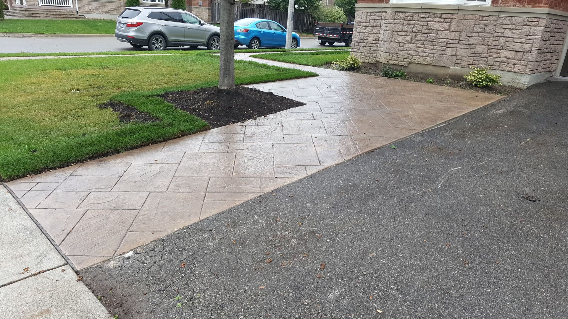 A car is parked on the side of the road next to a sidewalk.
