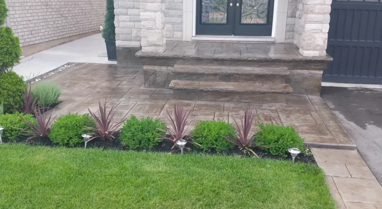 There is a brick walkway leading to the front door of a house.