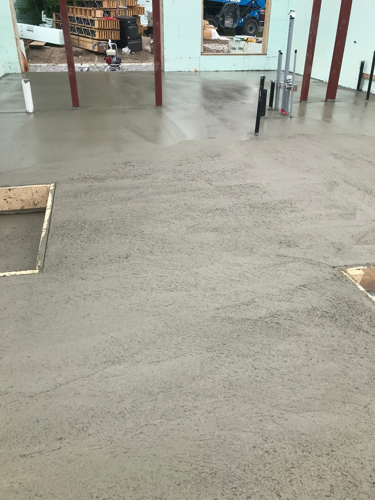A concrete floor is being built in a building under construction.