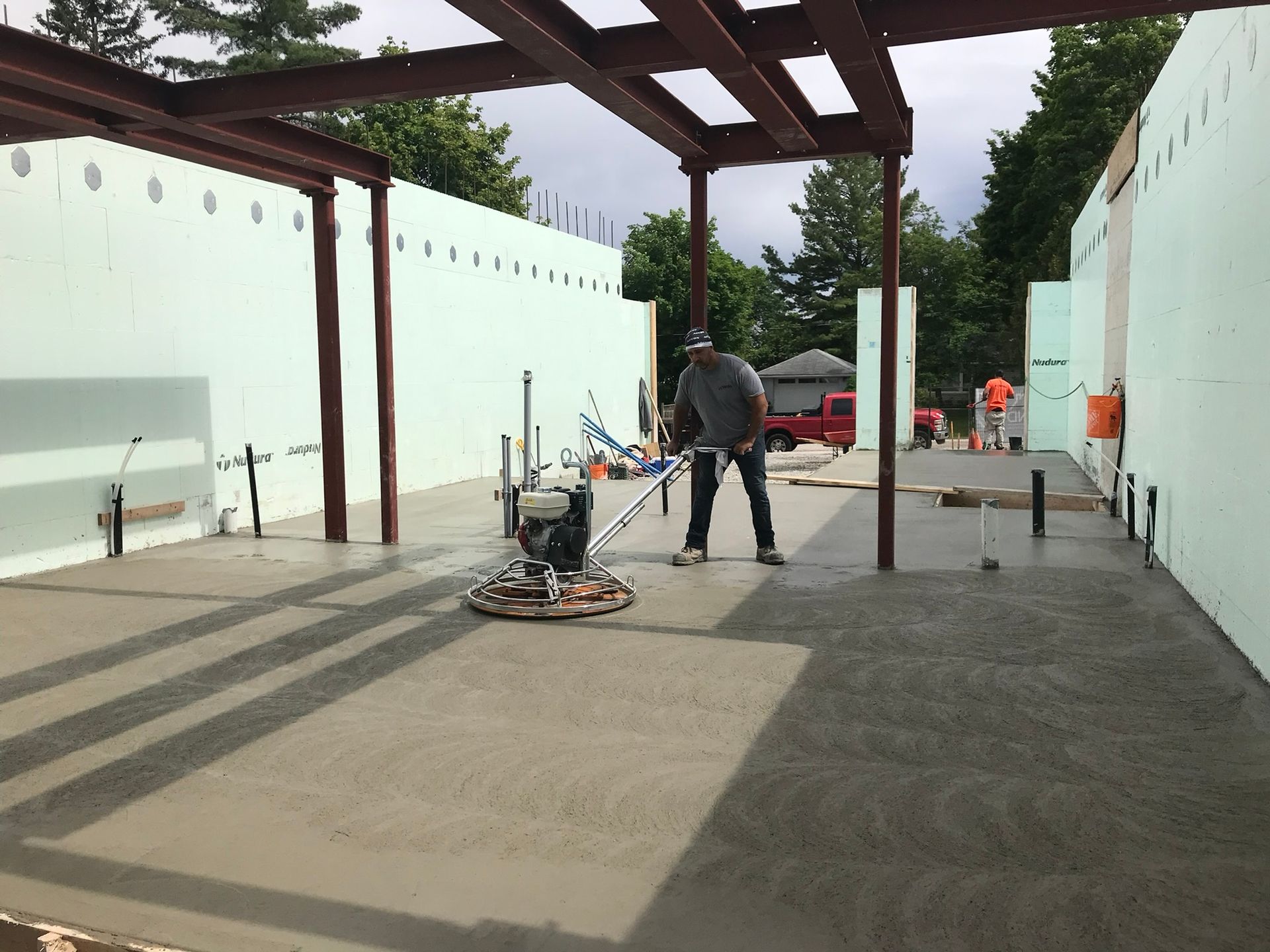 A man is working on a concrete floor with a machine