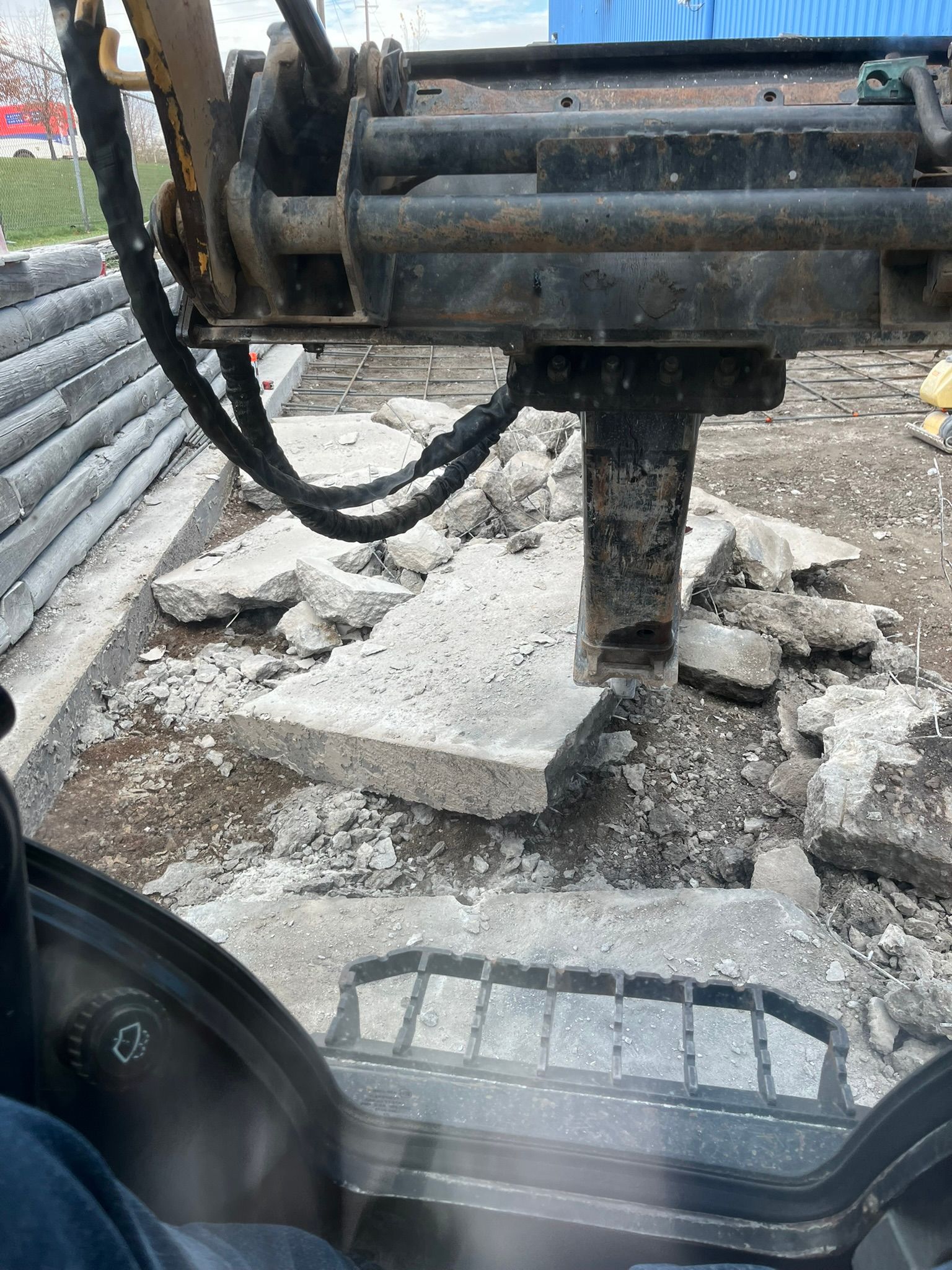 A person is driving a tractor on a construction site.