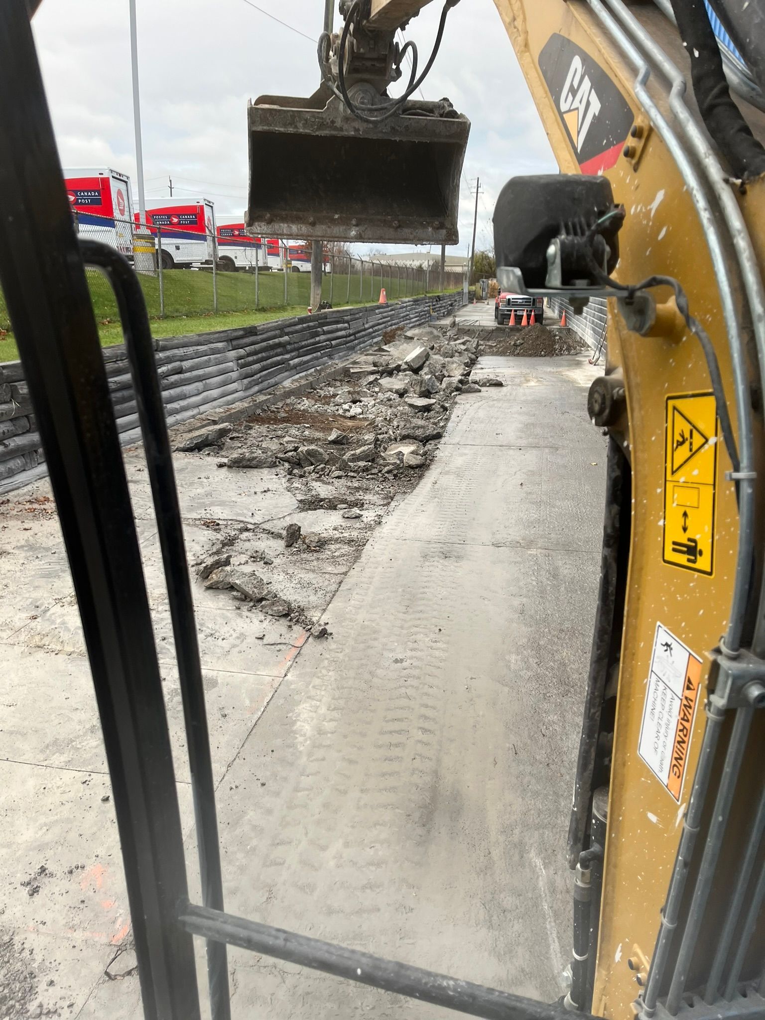A cat excavator is digging a hole in the ground.