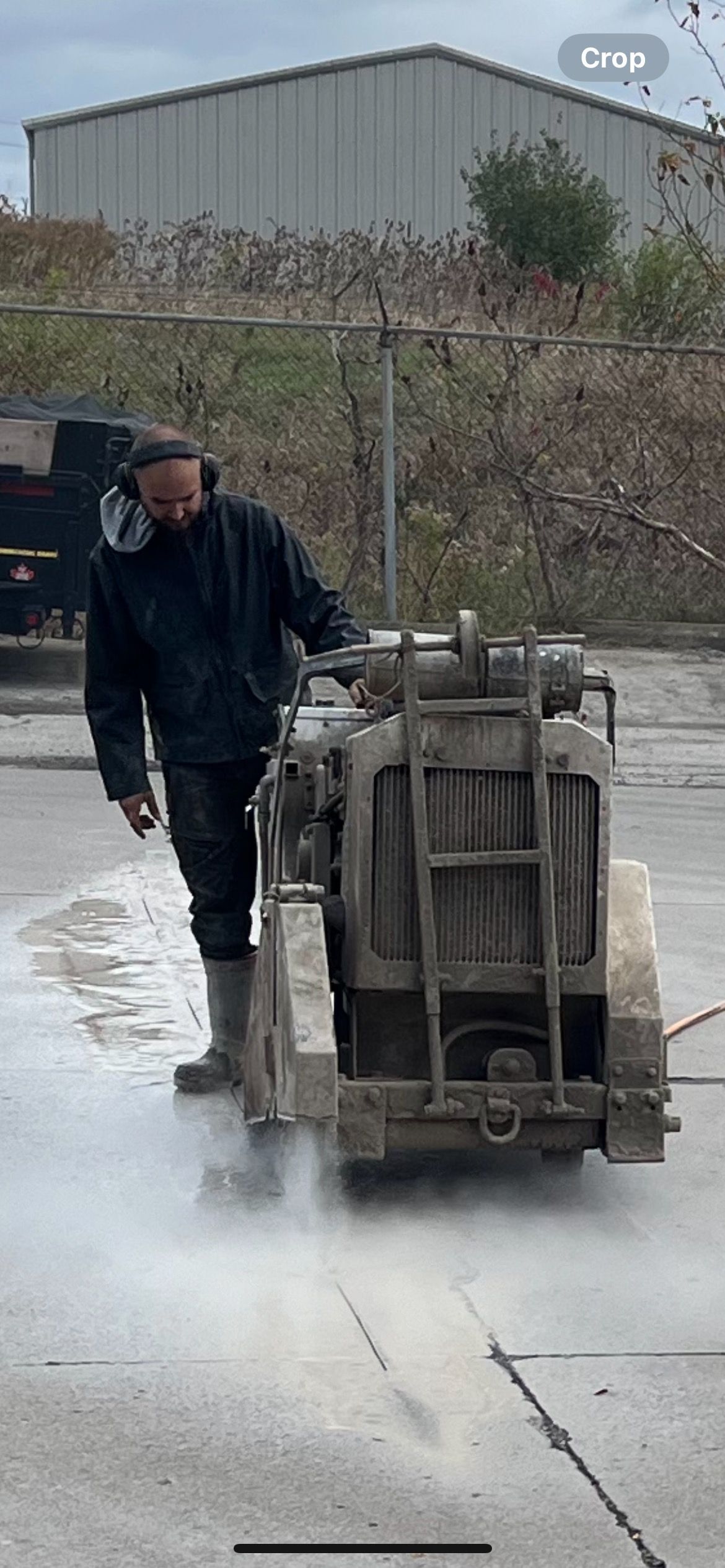 A man is cutting concrete with a machine.