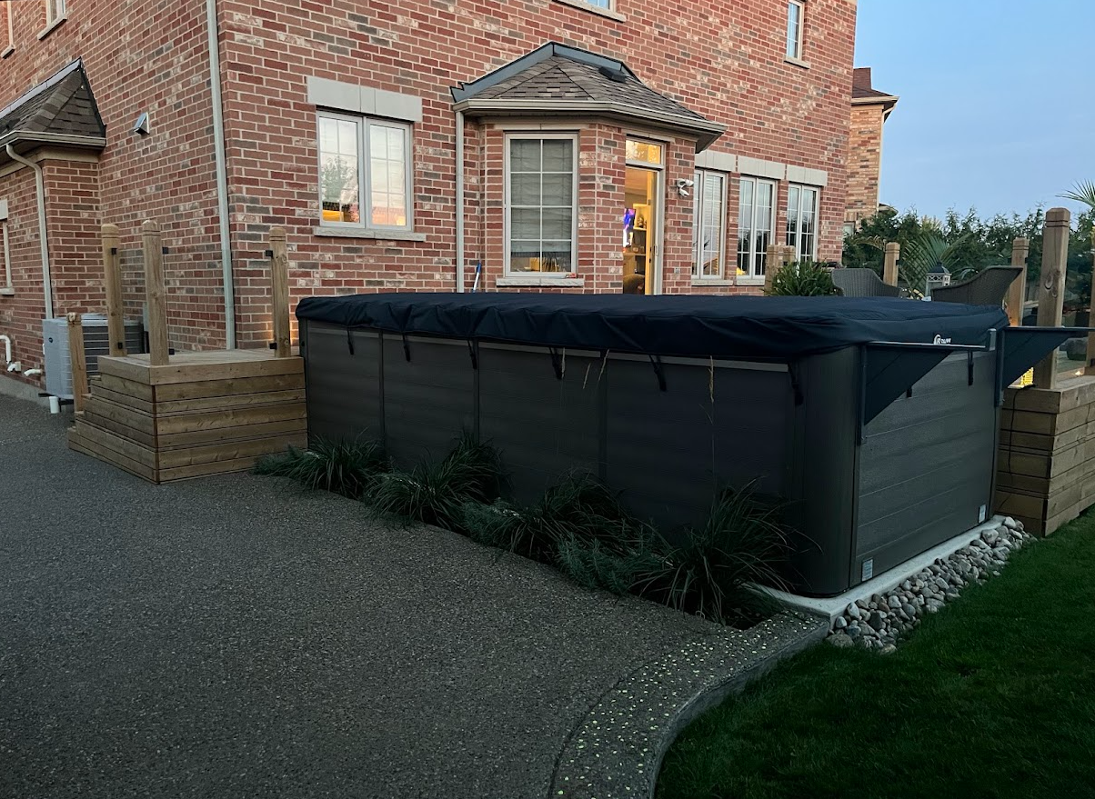 A brick house with a hot tub in front of it