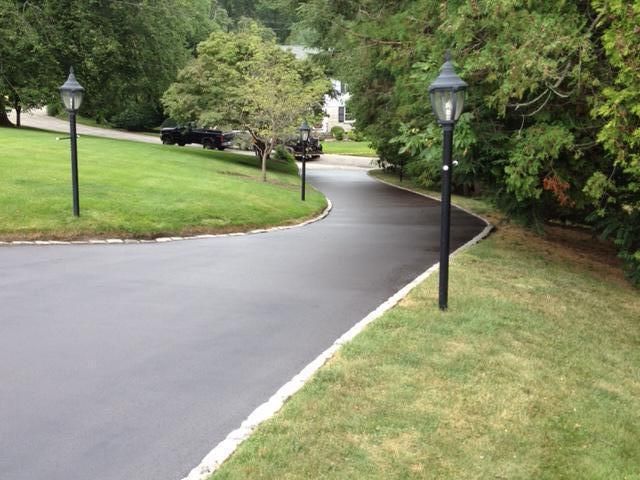 There are two street lights on the side of the road.