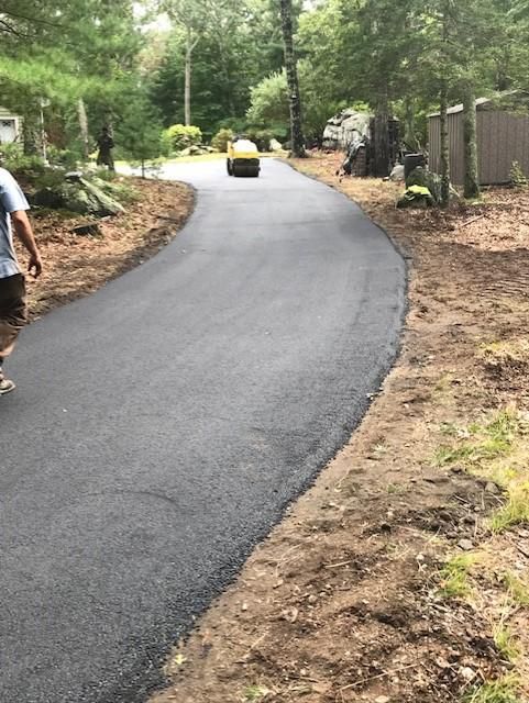 A man is walking down a newly paved road