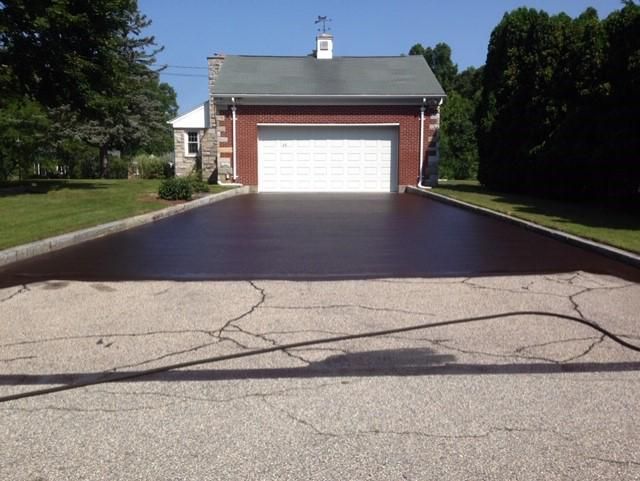 A driveway leading to a garage with a white door