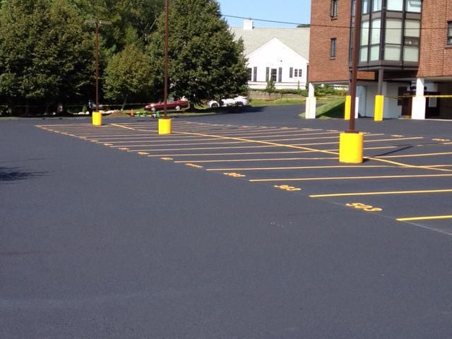 A parking lot with a brick building in the background