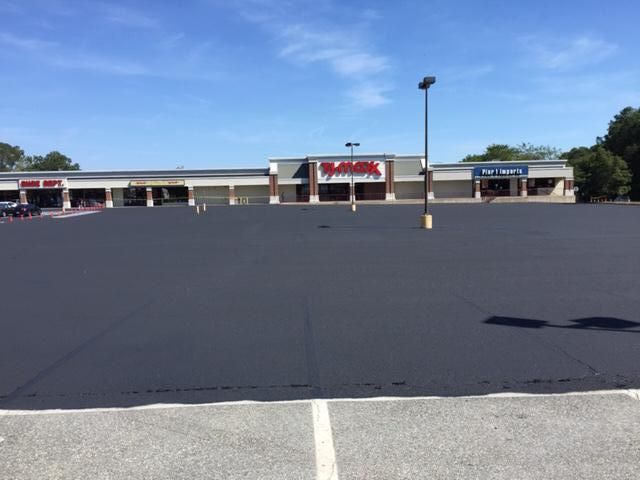 An empty parking lot in front of a store called kmart