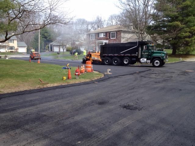 A dump truck is parked on the side of a road