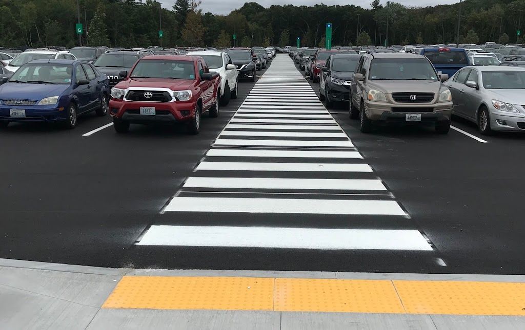 A parking lot with a zebra crossing in the middle