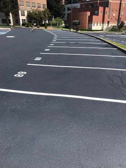 A parking lot with a building in the background
