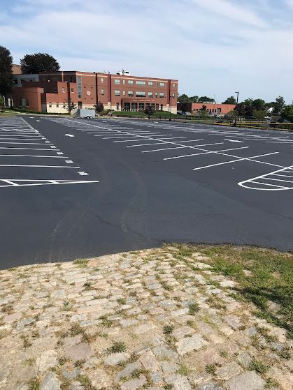 A parking lot with a large building in the background.