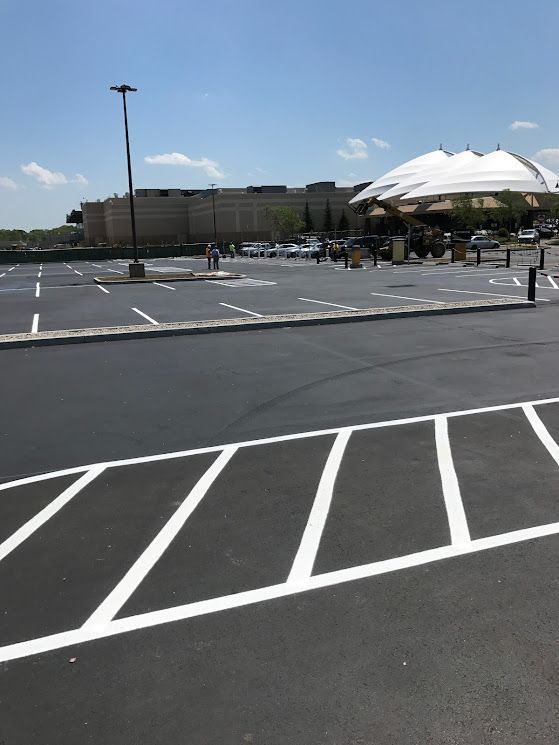 A parking lot with a large building in the background