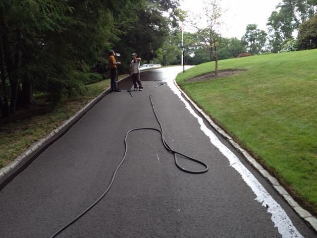 A hose is laying on the side of a road
