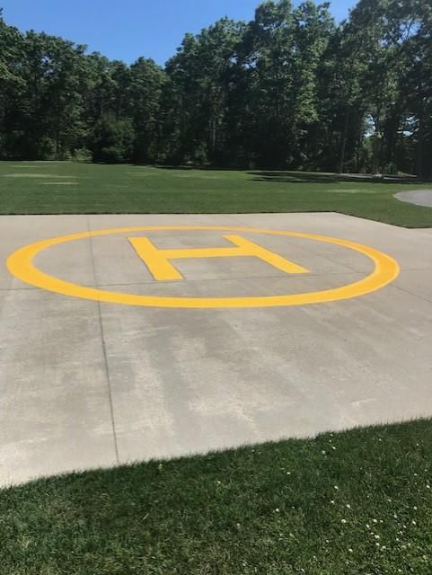 A yellow circle with the letter h painted on it