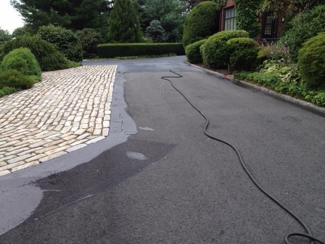 A hose is attached to the side of a road