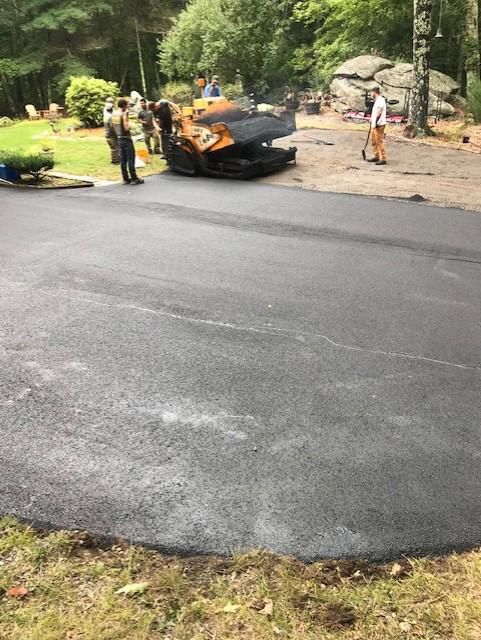 A group of people are working on a road.
