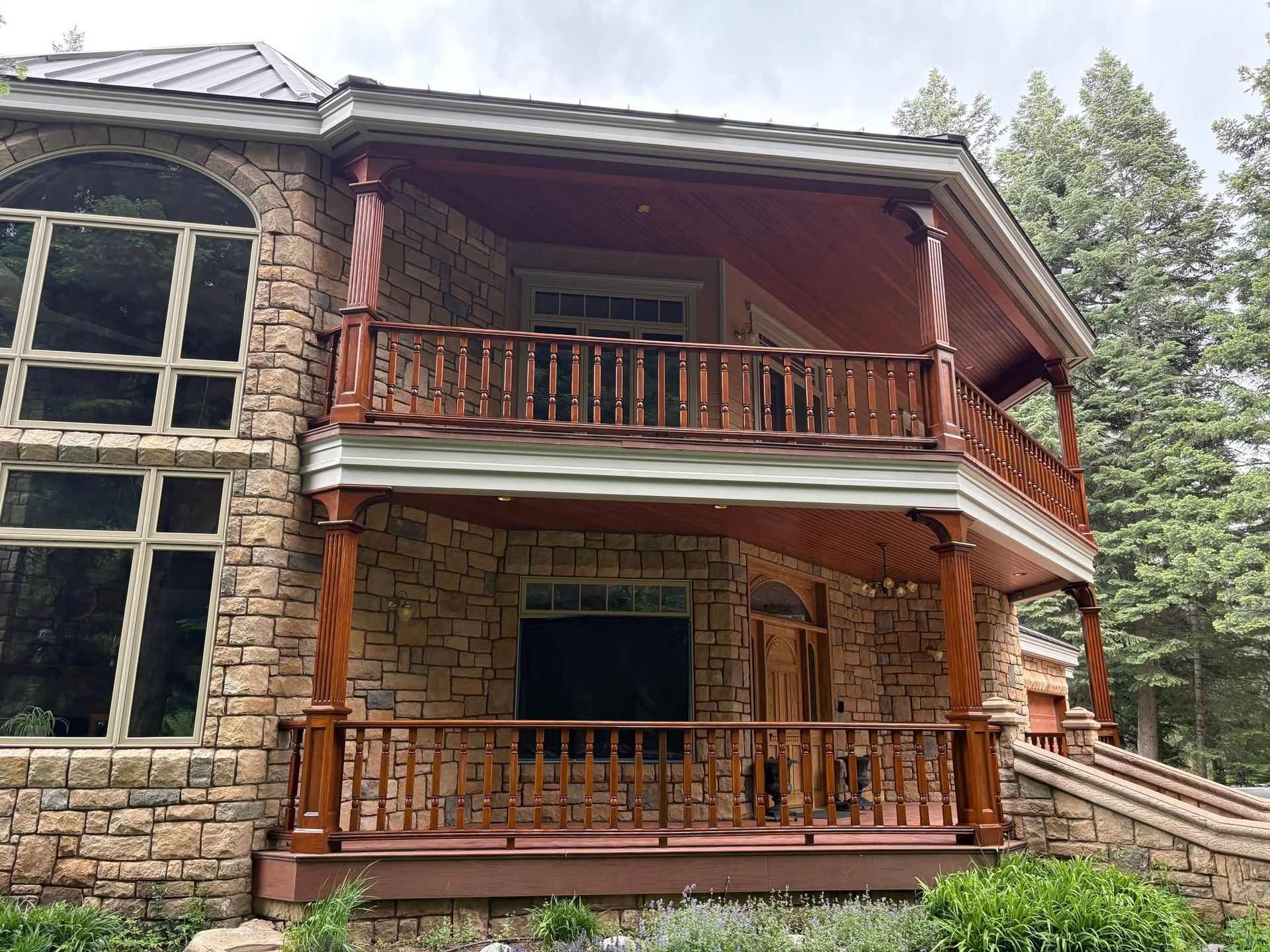 A house with three garage doors and a door. The house has received exterior paint service