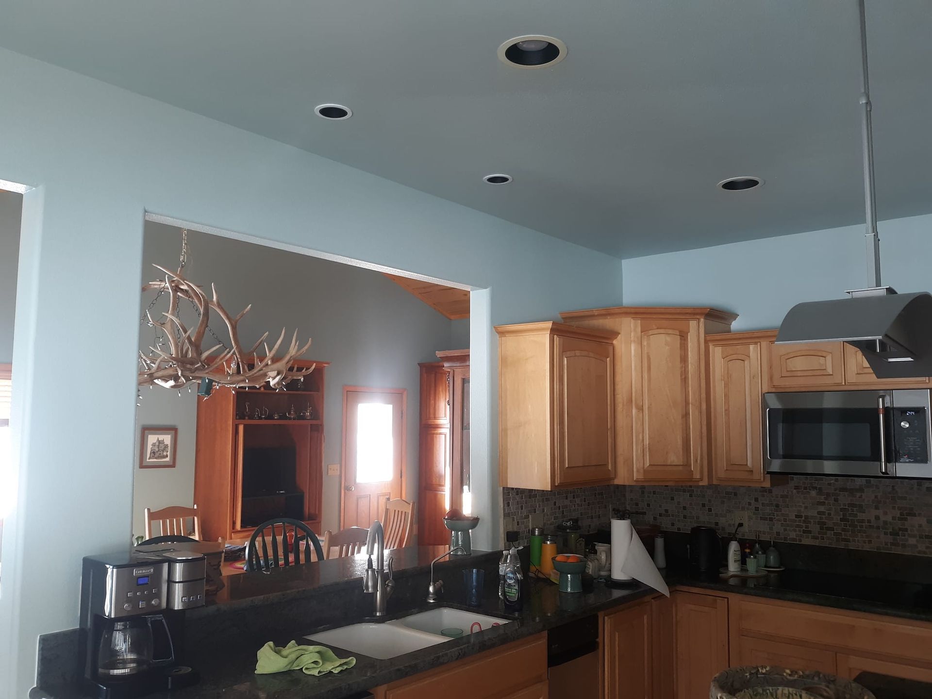 A kitchen with fresh paint. stainless steel appliances and wooden cabinets