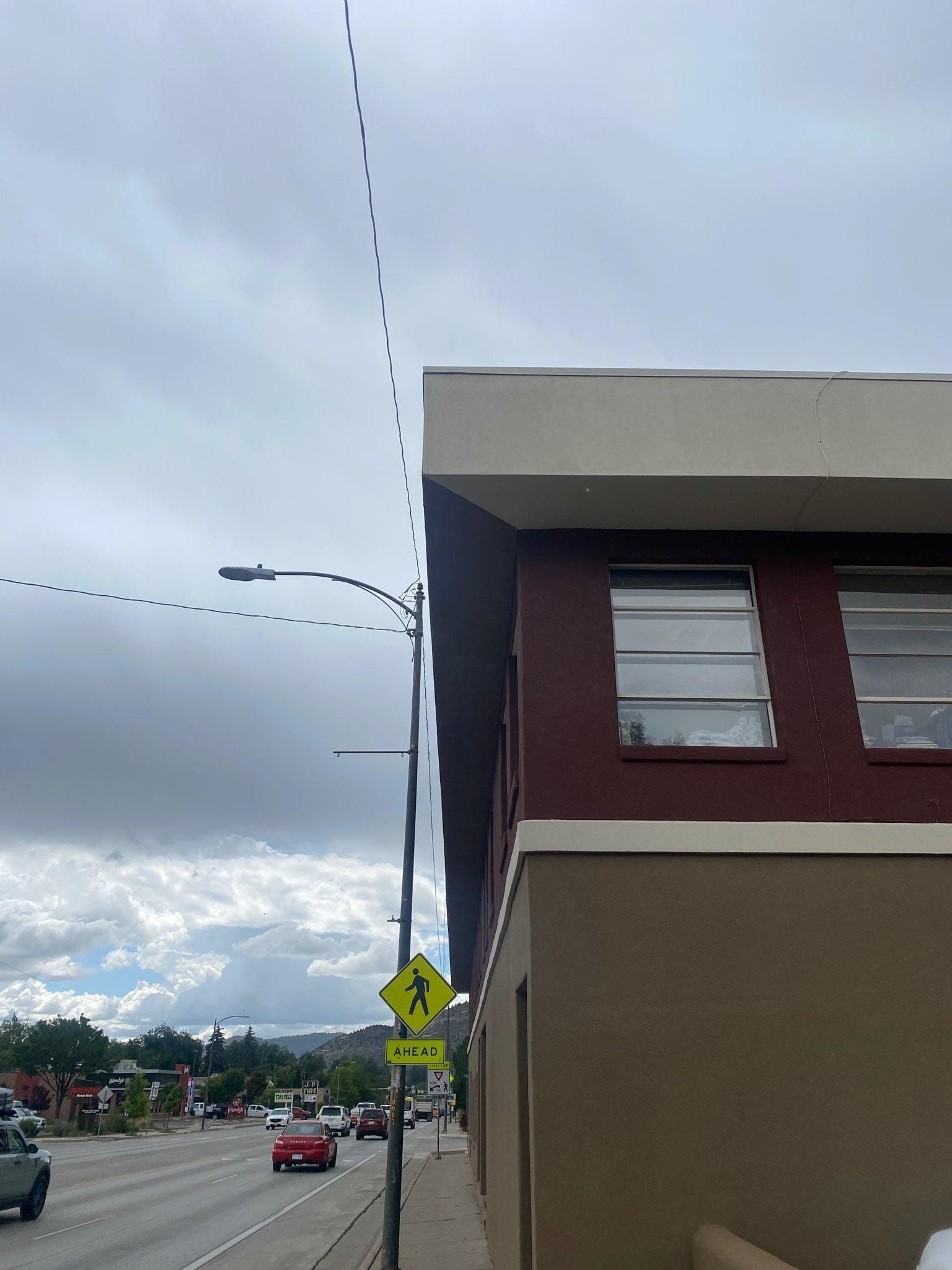 A building with a yellow sign on the side of it