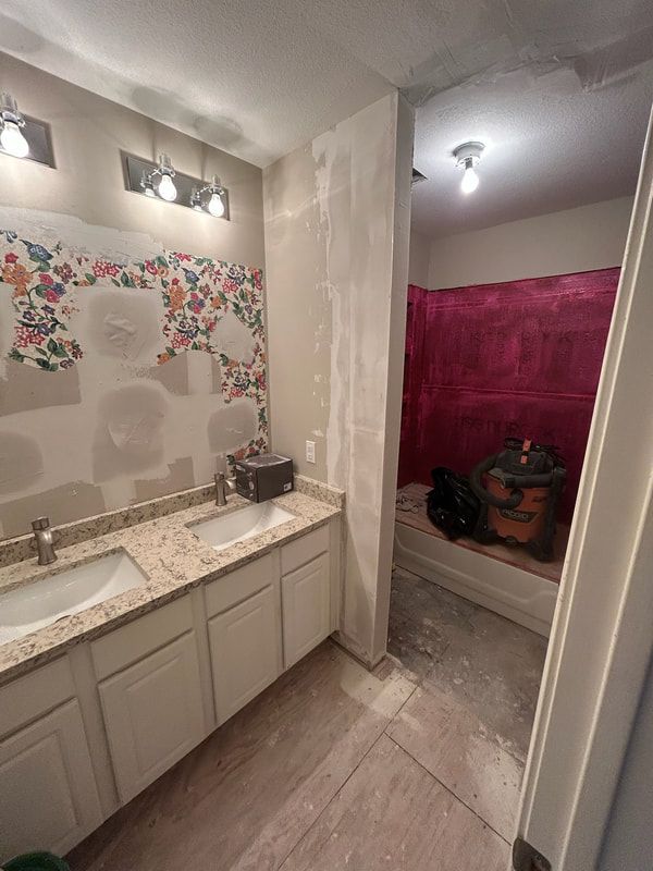 A bathroom with two sinks and a pink shower.