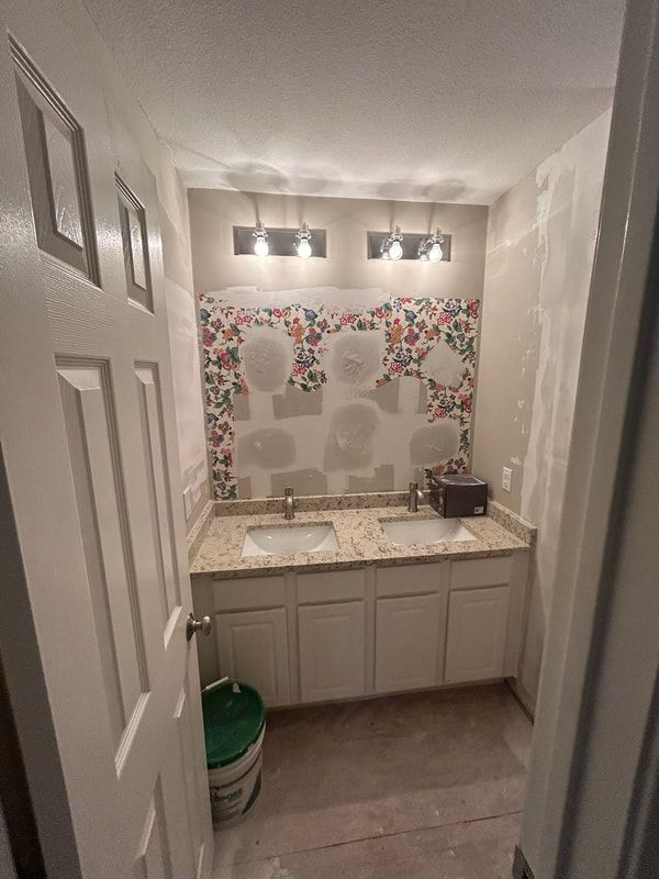 A bathroom with two sinks and a mosaic wall.