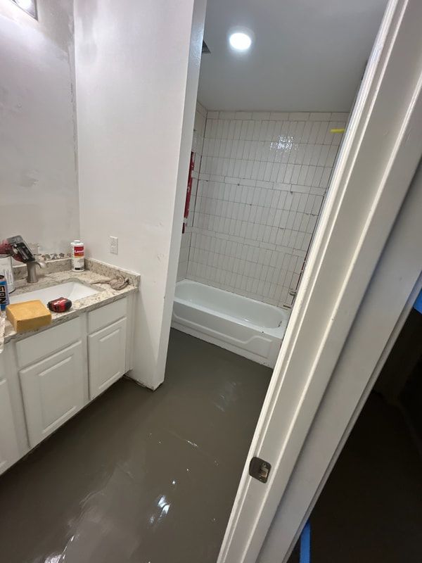 A bathroom with a sink and a bathtub in it.