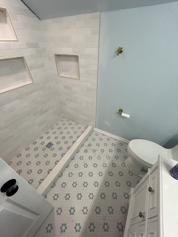 A bathroom with a walk in shower and a toilet.