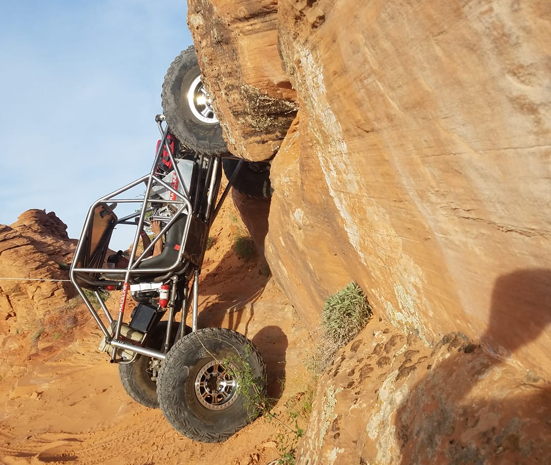 rock crawling jeep vertical on sandstone rock wall