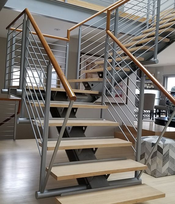 A staircase with wooden steps and a metal railing