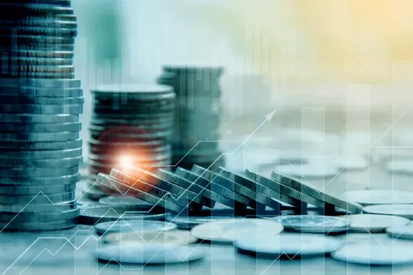 A bunch of coins stacked on top of each other on a table.