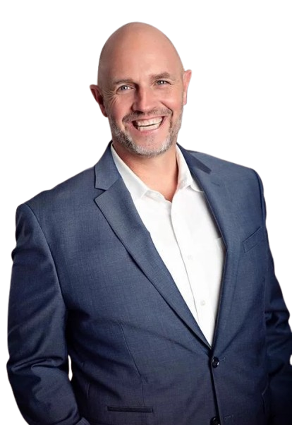 A bald man in a blue suit and white shirt is smiling.
