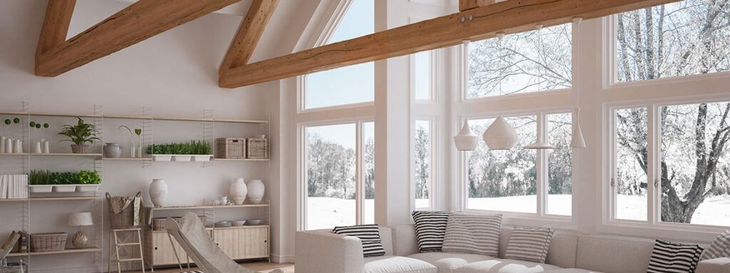 A living room with a lot of windows and a couch.