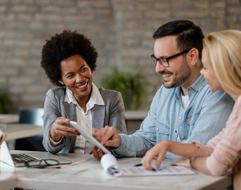 A lobby with a couch a table and a chandelier
