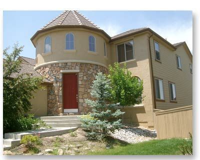 A large house with a round roof and a red door
