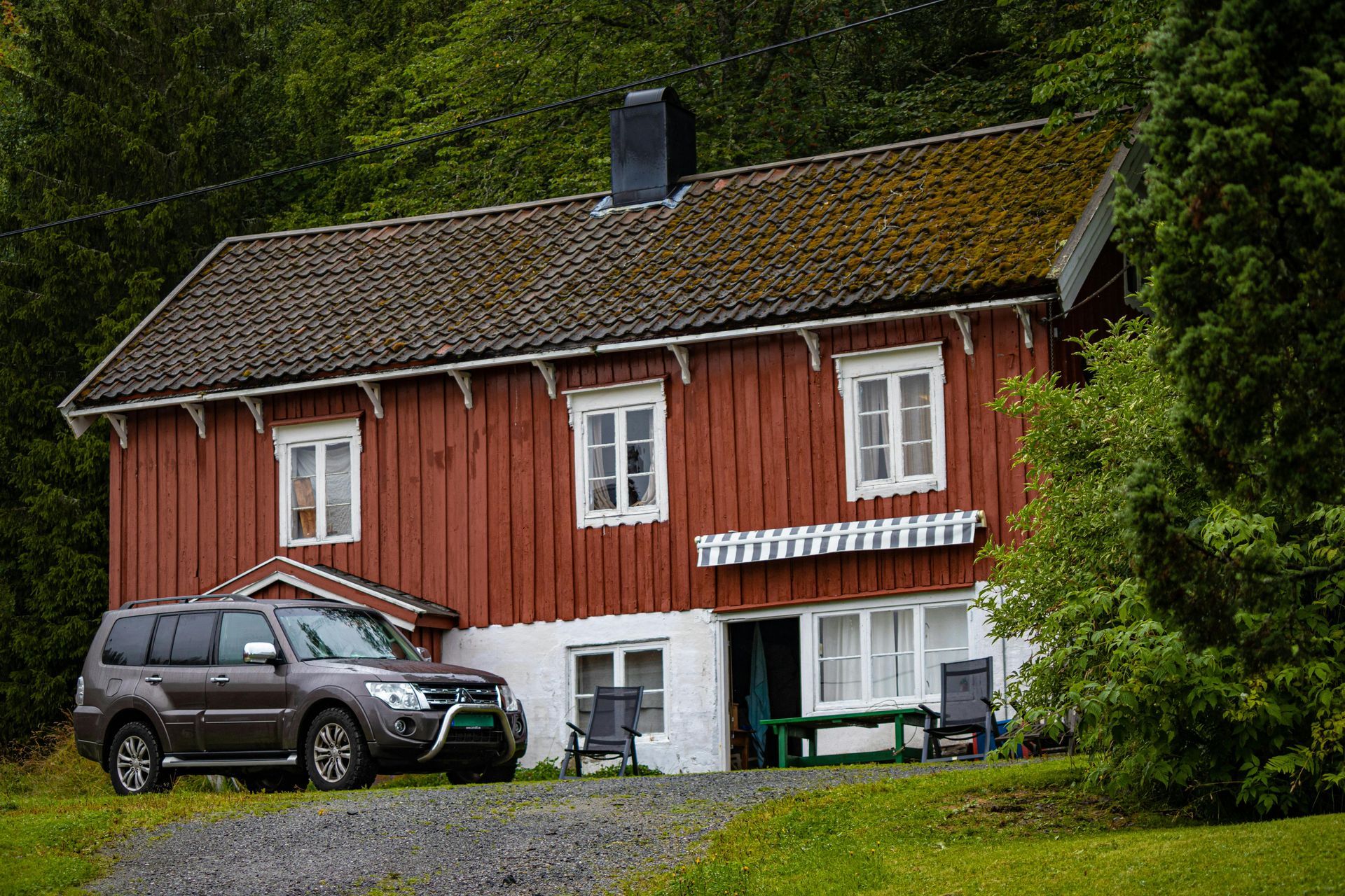 A large house with a round roof and a red door