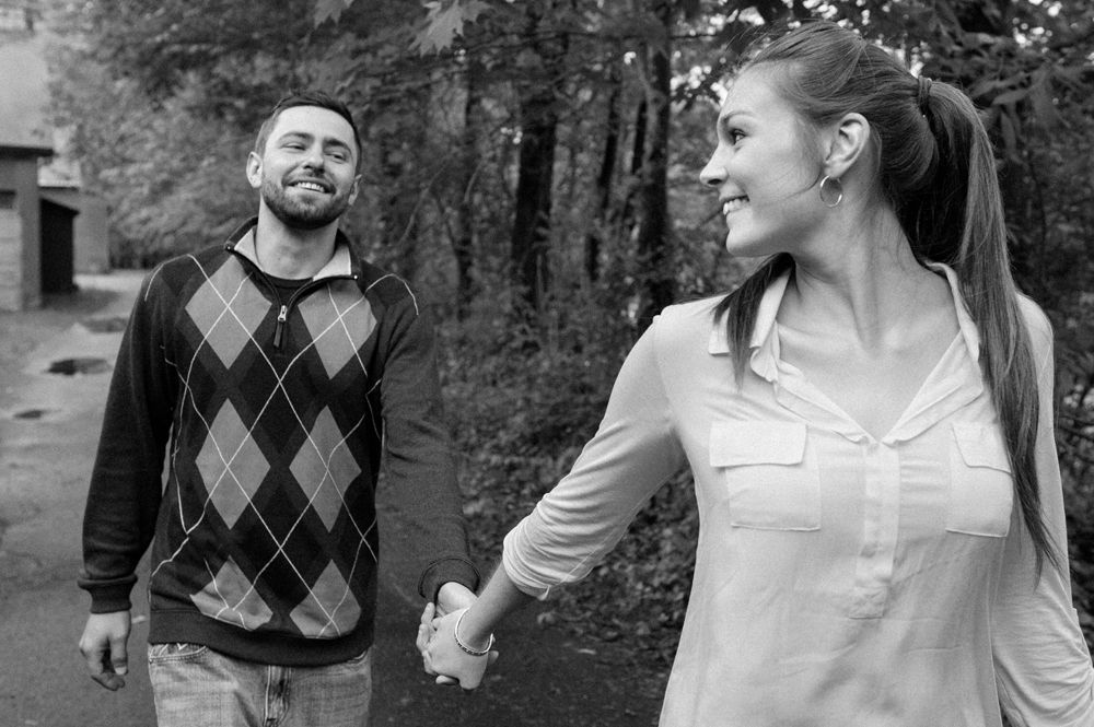 Wedding party toasting with beer bottles in an outdoor setting; sunflowers and smiles.
