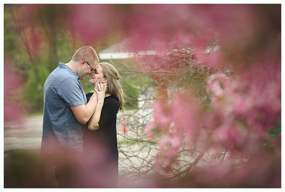 Wedding photos of a couple in a forest setting. The bride holds a sunflower bouquet. The groom kisses the bride.